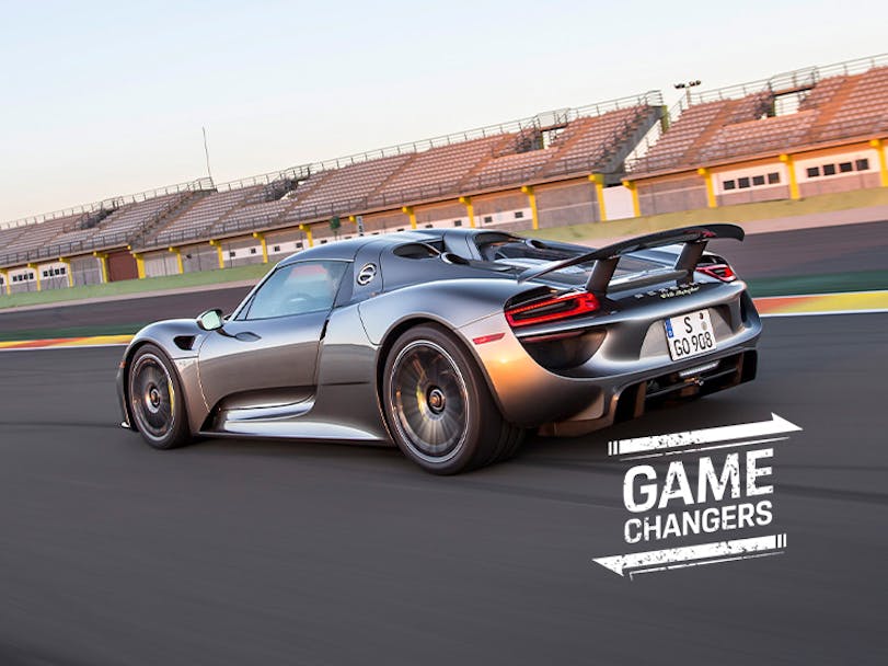 Grey metallic Porsche 918 Spyder driving on racetrack