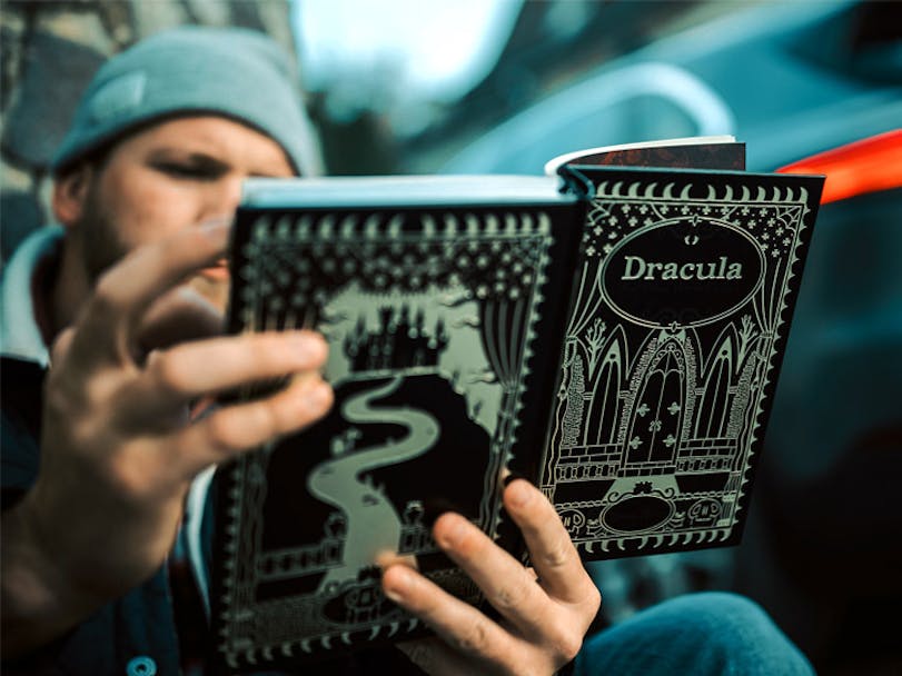Man reading Dracula Book