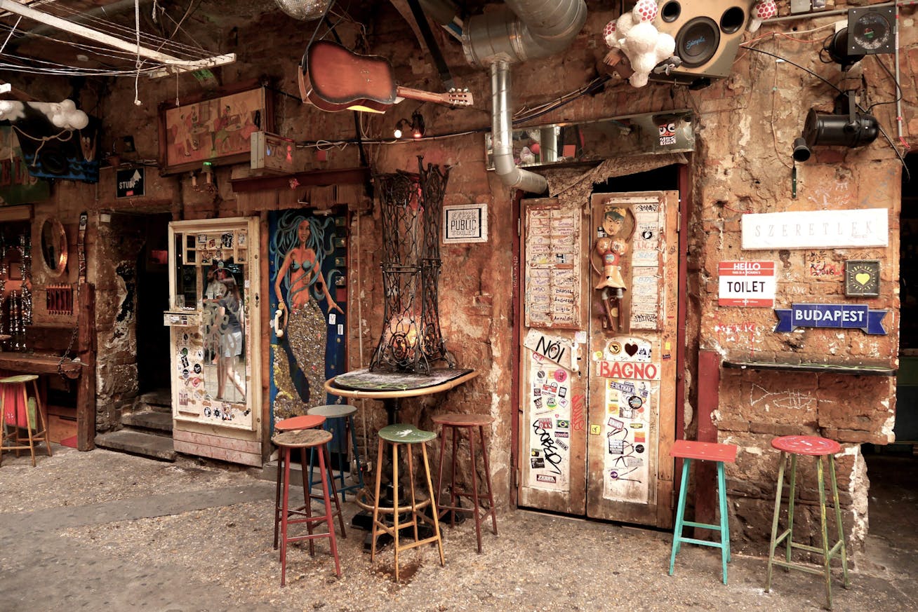 Restaurant interior with eccentric décor and figures suspended from ceiling